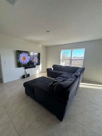 a living room with a couch and a flat screen tv