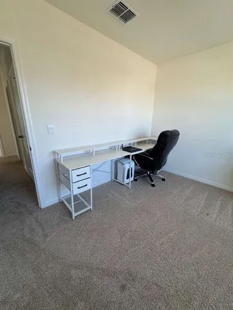 a workspace with furniture and a ceiling fan