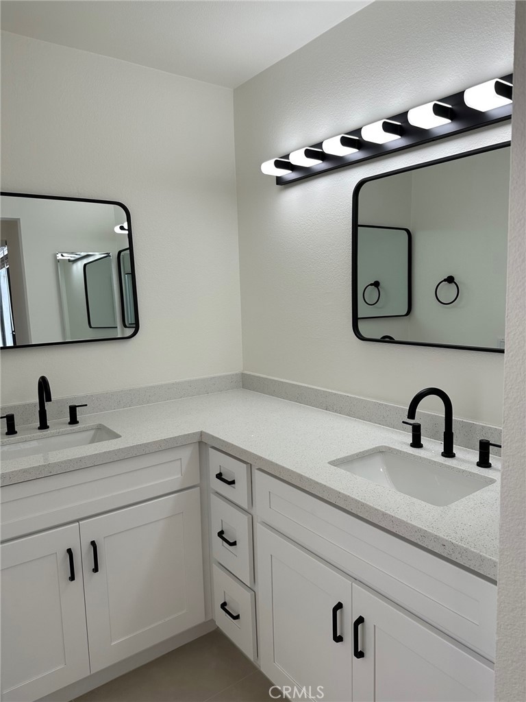 28142 Mariposa, Unit 154 Laguna Niguel, CA 92677 - Photo 16 of 35 a bathroom with a sink and a mirror
