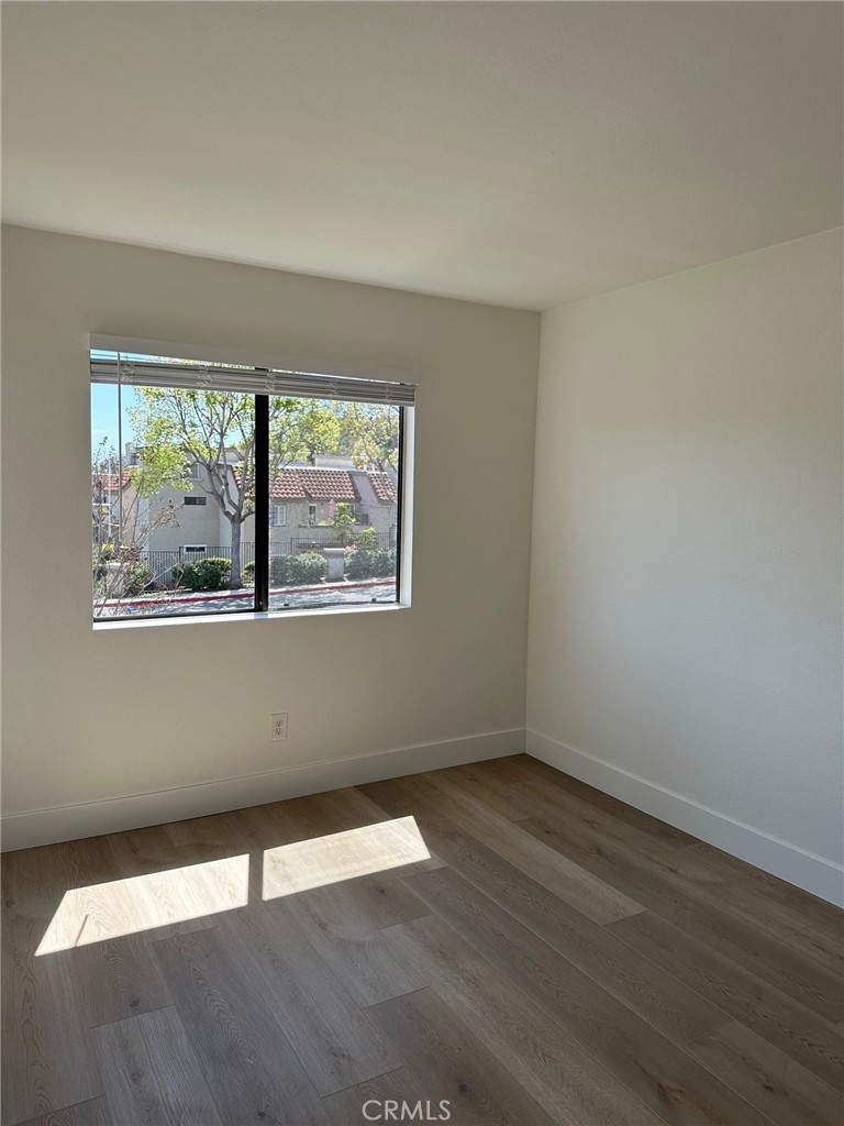 28142 Mariposa, Unit 154 Laguna Niguel, CA 92677 - Photo 19 of 35 an empty room with wooden floor and windows