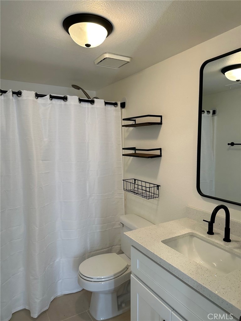 28142 Mariposa, Unit 154 Laguna Niguel, CA 92677 - Photo 21 of 35 a bathroom with a sink a toilet and a mirror