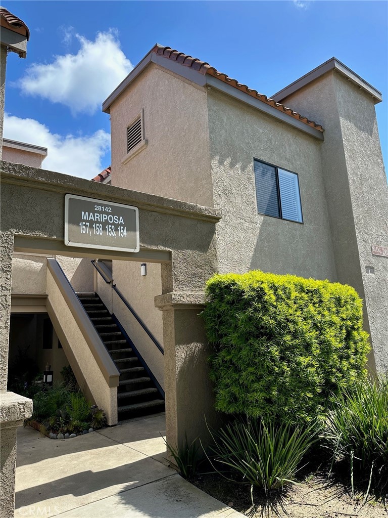 28142 Mariposa, Unit 154 Laguna Niguel, CA 92677 - Photo 3 of 35 a front view of a house with garage and plants