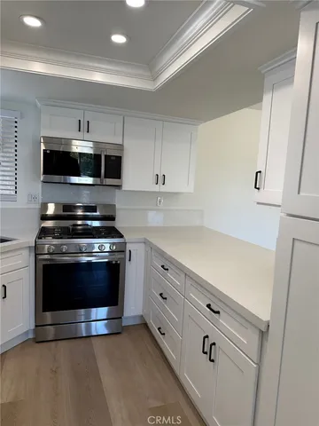 a kitchen with granite countertop a stove and a microwave