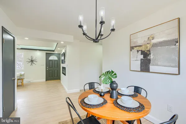 a kitchen with stainless steel appliances granite countertop a dining table and chairs