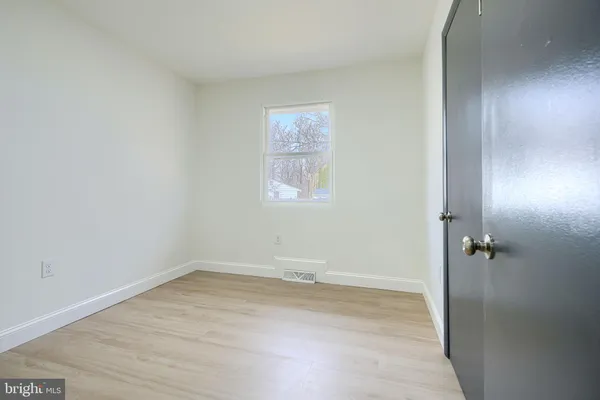 a view of a hallway with closet and bathroom