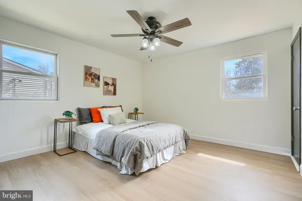 a bedroom with a chandelier and a chandelier fan