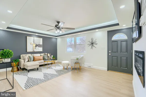 a kitchen with a dining table cabinets appliances and wooden floor