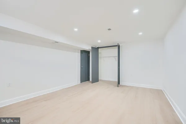 a bathroom with a sink a toilet a mirror and shower