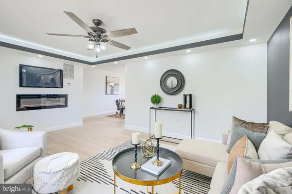 a living room with furniture a chandelier and a window
