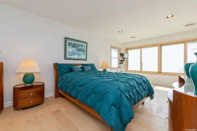 a spacious bedroom with a bed and a couch