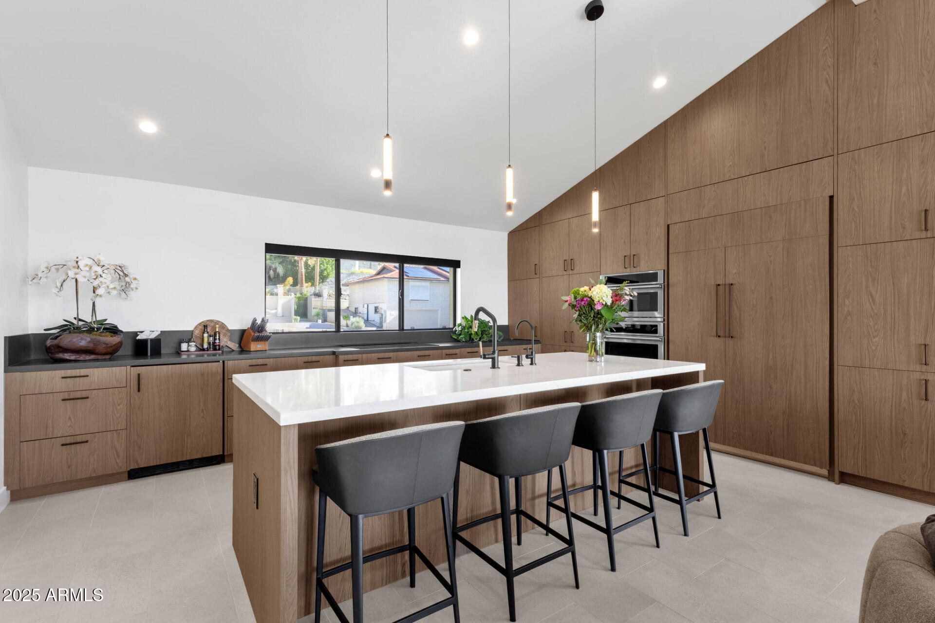 7112 North 23rd Way Phoenix, AZ 85020 - Photo 11 of 50 a kitchen with stainless steel appliances kitchen island granite countertop a table chairs sink and cabinets