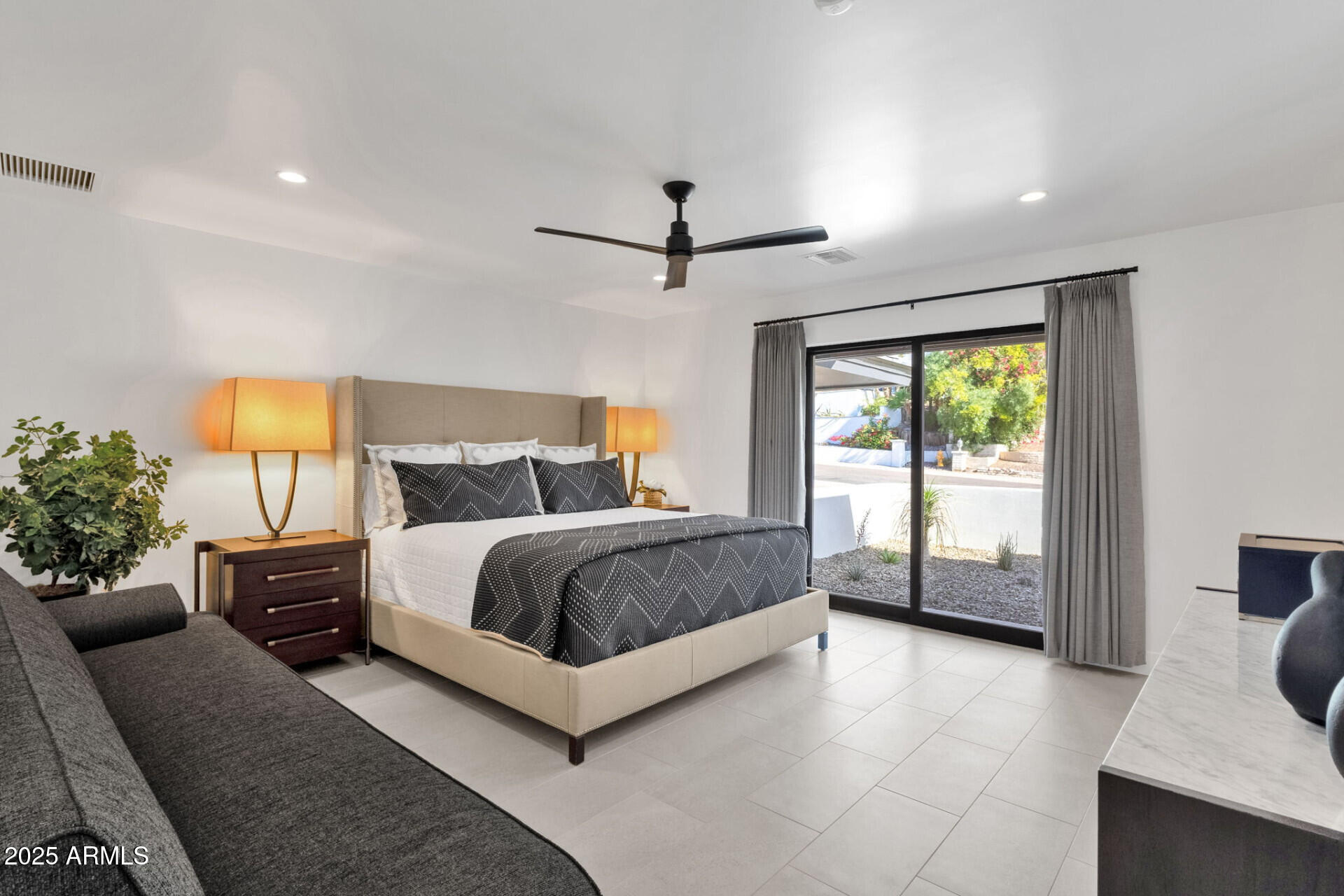 7112 North 23rd Way Phoenix, AZ 85020 - Photo 21 of 50 a bedroom with a large bed and a chandelier fan