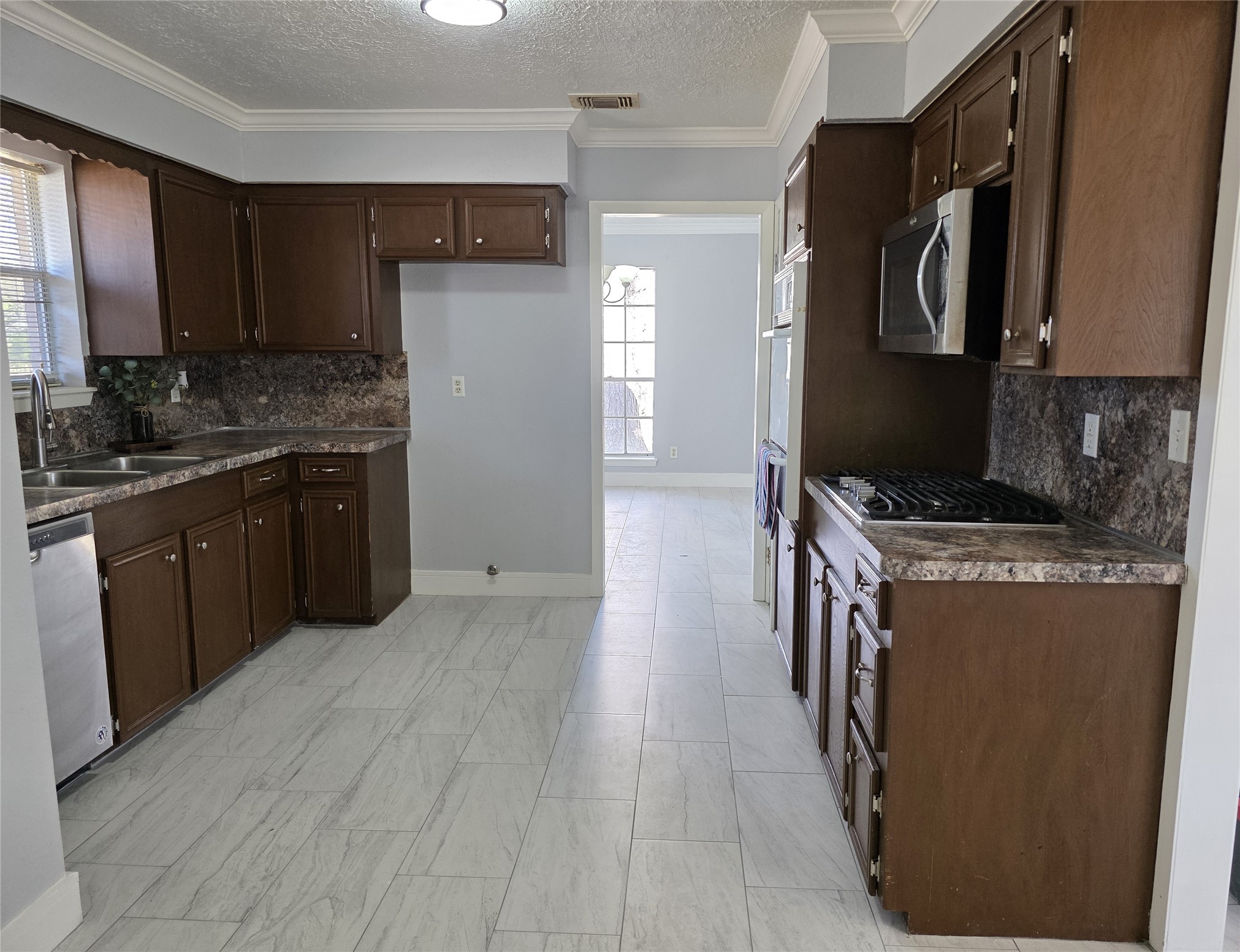 1819 Papoose Trail Crosby, TX 77532 - Photo 15 of 26 a kitchen with stainless steel appliances granite countertop a stove a sink and a refrigerator