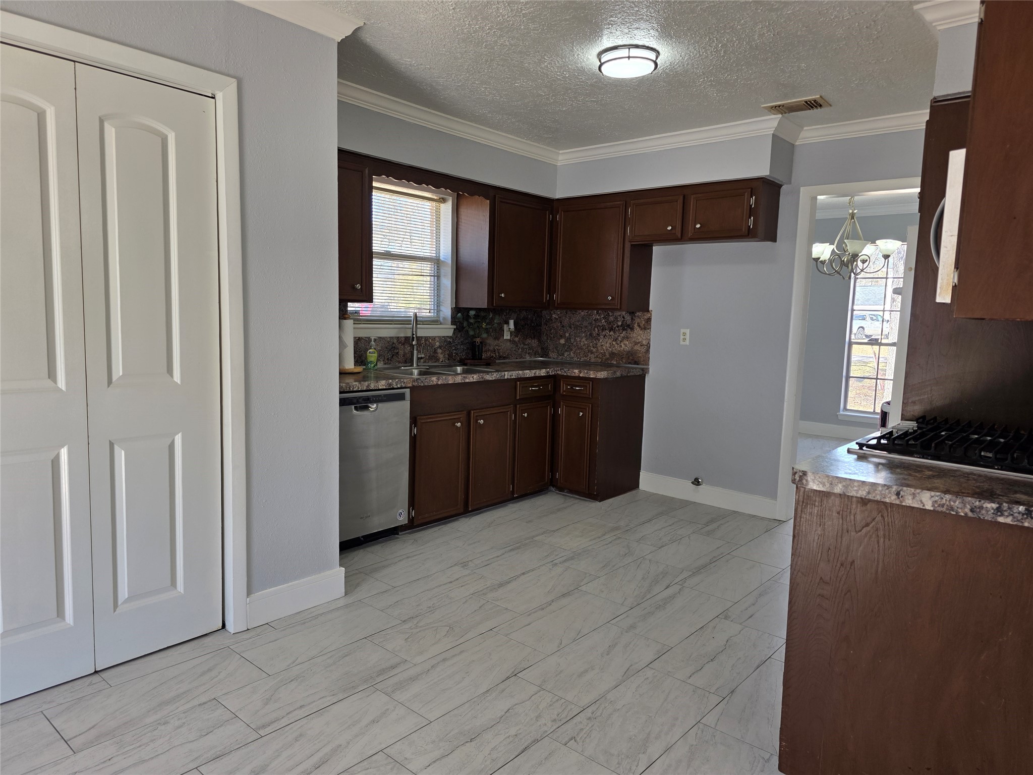 1819 Papoose Trail Crosby, TX 77532 - Photo 16 of 26 a kitchen with stainless steel appliances granite countertop a refrigerator oven a sink dishwasher and a refrigerator