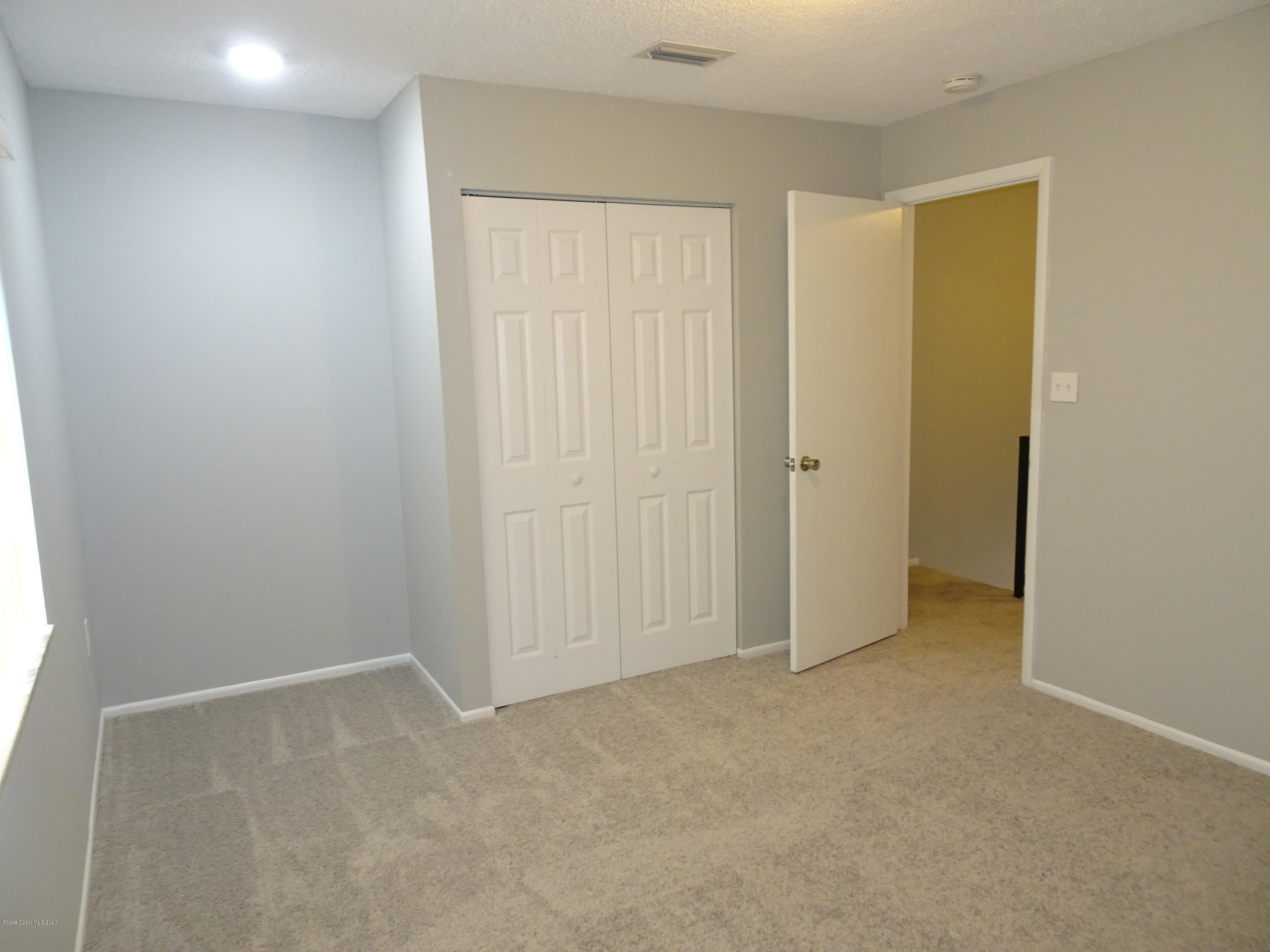 4875 Sisson Road Titusville, FL 32780 - Photo 7 of 14 an empty room with closet area