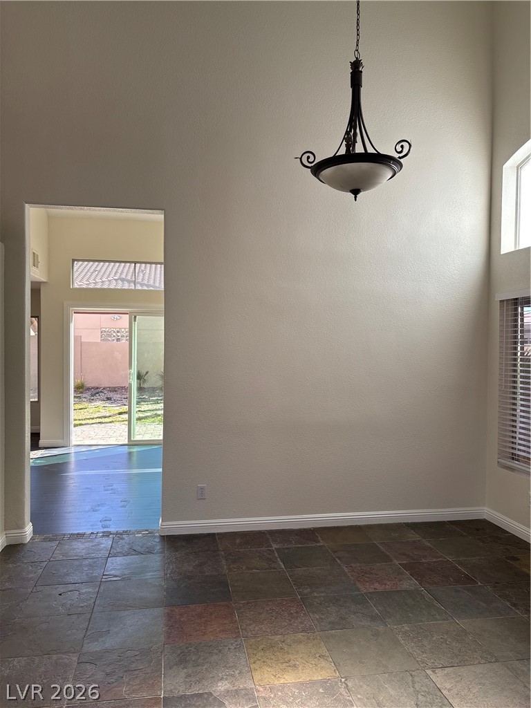 2670 Ridgewater Circle Henderson, NV 89074 - Photo 4 of 22 This interior space features vaulted ceilings, skylights, and durable tile flooring, creating an inviting atmosphere.