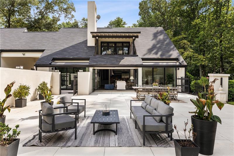9650 Coleman Road Roswell, GA 30075 - Photo 12 of 97 a view of house with patio outdoor seating and covered with trees