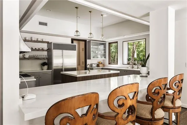a living room with furniture and floor to ceiling windows