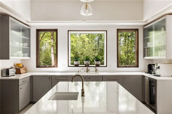 a living room with furniture and floor to ceiling window