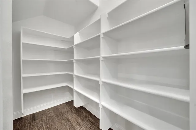 a view of a kitchen with a sink and wooden floor
