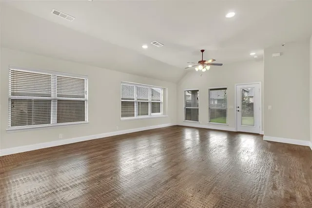 a large kitchen with a stove a sink and a refrigerator