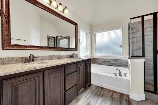 a view of empty room with wooden floor and windows