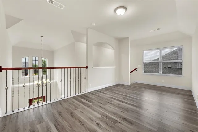 a view of an empty room and wooden floor