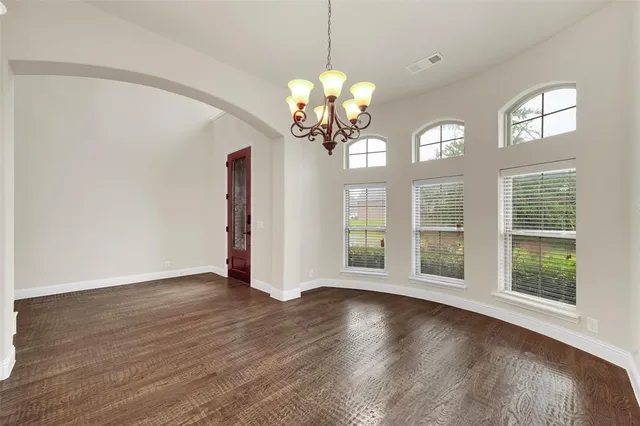 a view of a room with wooden floor and a large window