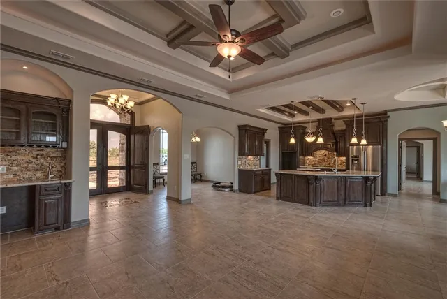 a kitchen with sink stove and refrigerator