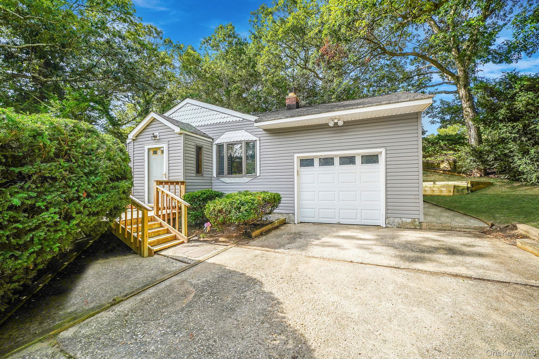254 Gibbs Pond Road Nesconset, NY 11767 - Photo 1 of 1 a front view of a house with a garden