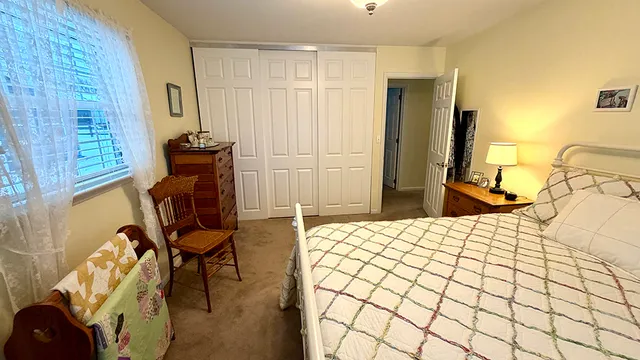 a bedroom with a bed and a table in it
