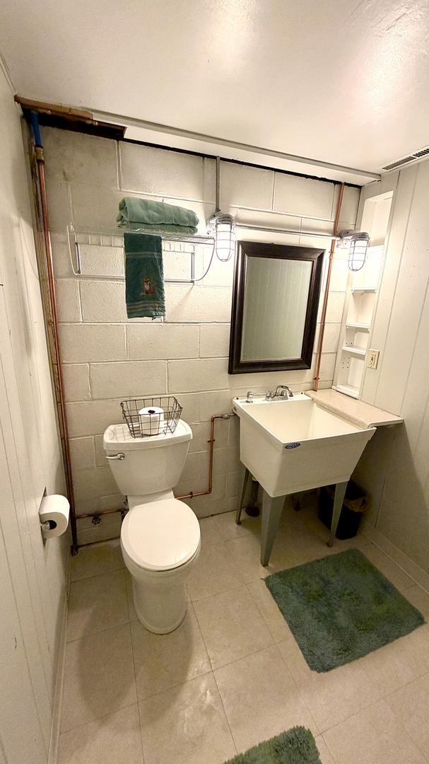 516 Christopher Street Morrison, IL 61270 - Photo 20 of 31 a bathroom with a toilet sink and mirror