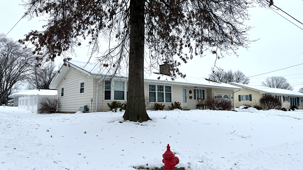 516 Christopher Street Morrison, IL 61270 - Photo 2 of 31 a view of a house with snow on the road