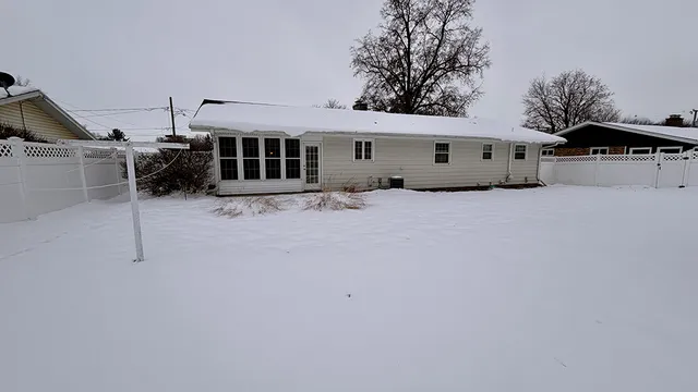 a view of a house with a snow in the yard