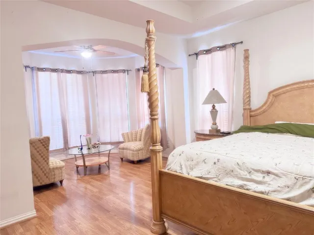 a spacious bedroom with a bed and a couch