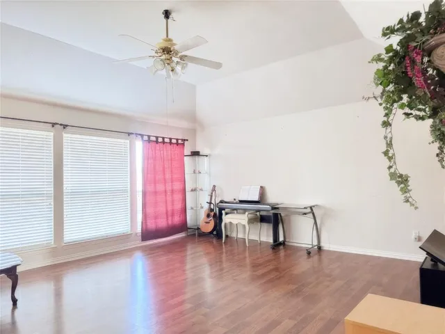 a view of a room with furniture and wooden floor
