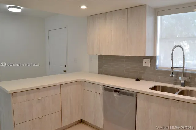 a kitchen with a sink and cabinets
