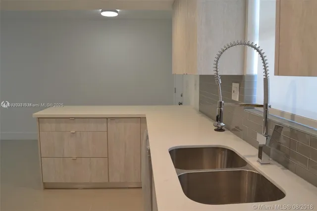 a view of a refrigerator in kitchen and a white cabinet