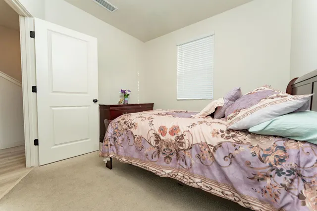 a bedroom with a bed and a window