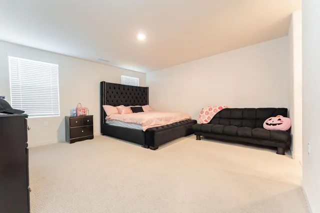 a bedroom with bed and a view of bedroom