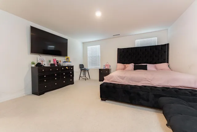 a bedroom with a bed and a flat screen tv