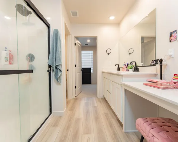 a bathroom with a sink a toilet a mirror and shower