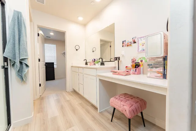 a en suite bathroom with a sink mirror and shower