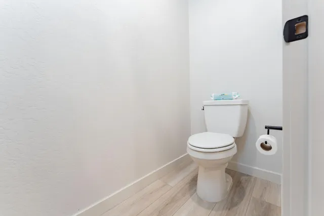 a white toilet sitting next to a white sink