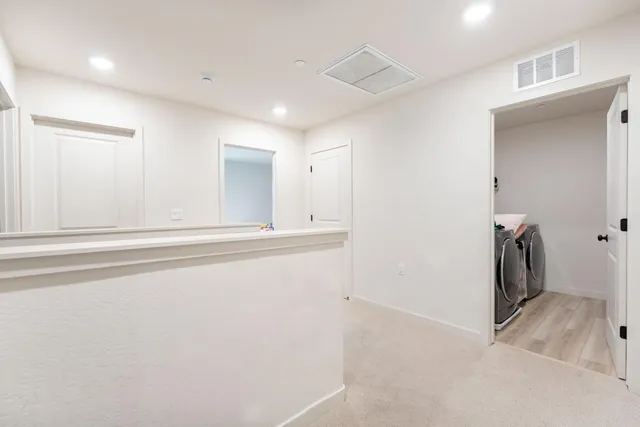 a view of a livingroom with a washer and dryer