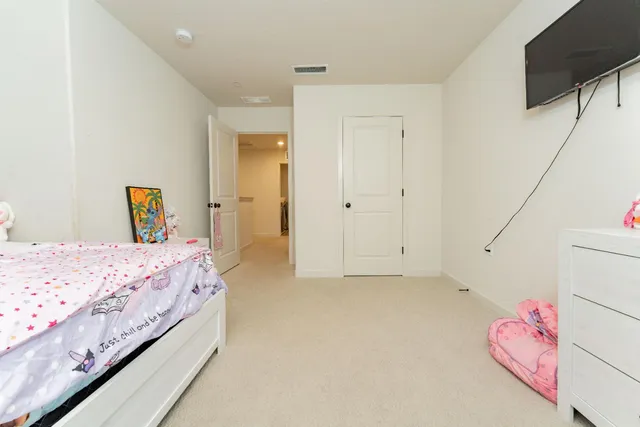 a bedroom with a bed and a flat screen tv