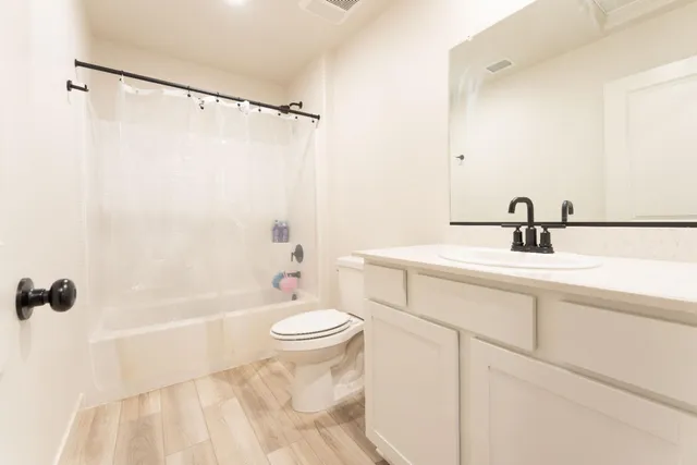 a bathroom with a sink toilet and shower