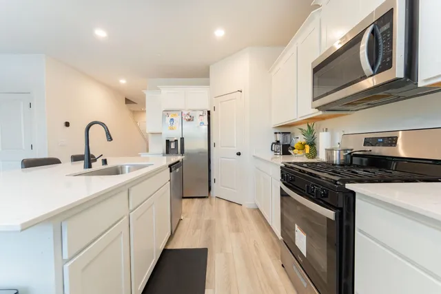 a kitchen with a sink stove and refrigerator