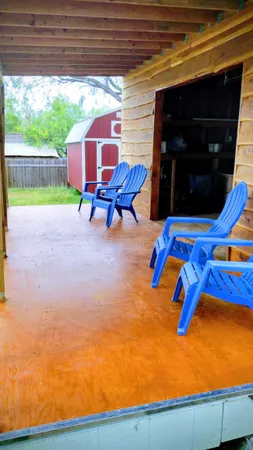 a view of a backyard with table and chairs and potted plants