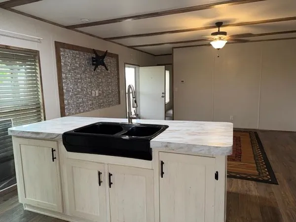 a kitchen with a sink a stove and a refrigerator